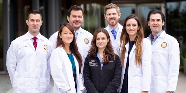 3 of 3, group wearing white coats